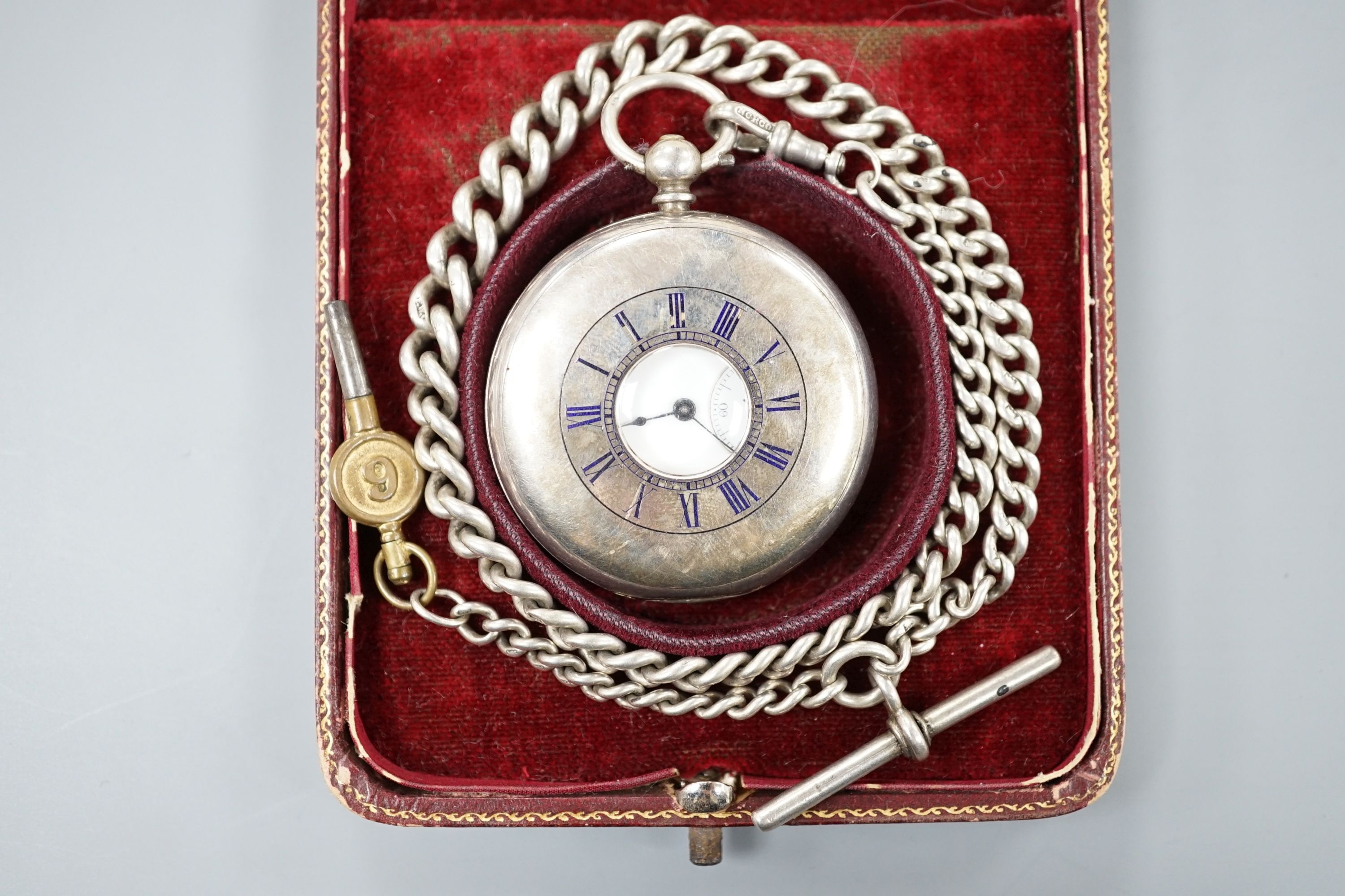 A 925 half hunter keywind pocket watch, cased diameter 46mm, on a silver albert with watch key.